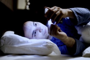 Man using his mobile phone in the bed